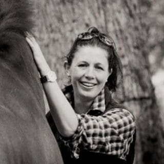 Black and white photo of Sarah Young with horse.
