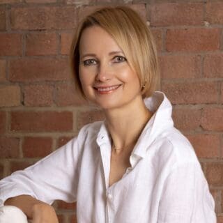 Profile photo of Natalie Miller wearing white shirt and smiling at camera