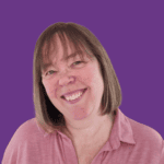 Theresa smiling at the camera, with shoulder-length light brown hair and a fringe, wearing a pink collared top against a plain purple background.