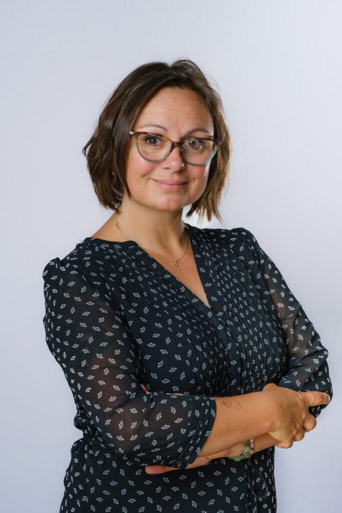 Profile image of Professor Nancy Dolye. She is a white woman with medium length brown hair and glasses. She is wearing a black shirt.