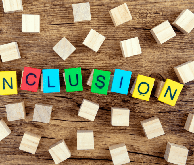 Wooden blocks with the word 'inclusion' spelt out in multi-colour.