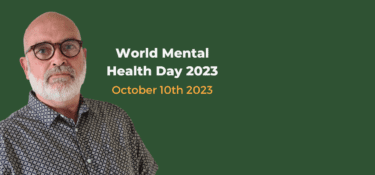 Image of Paul Stevenson in a patterned shirt with glasses on, against a green background. Text to the right reads 'World Mental Health Day 2023, October 10th 2023'