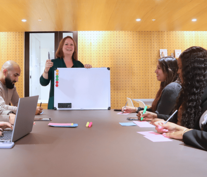 Group of collegues around a table discussing neurodiversity services
