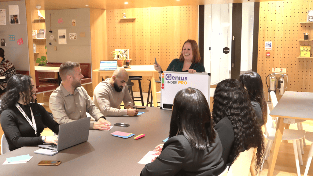 Team of people around a table discussing the benefits of the new strengths screener the Genius Finder Pro