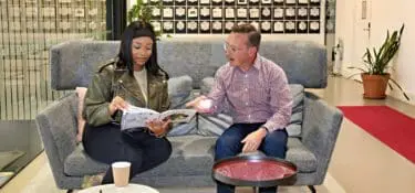 two people talking on a couch