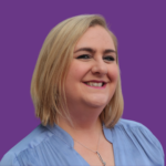 Professional headshot of Kelly Bristow smiling, with shoulder-length blonde hair, wearing a light blue blouse, against a purple background