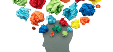 Silhouette of a head with scrunched up multi-coloured paper surrounding it
