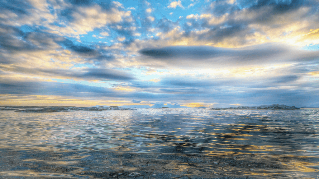 Image of the calm sea on a sunny, cloudy day