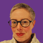 Head-and-shoulders portrait of Morwenna Stewart with short grey hair and round black glasses, looking directly at the camera with a slight smile. They are wearing a light-coloured textured high-neck jumper against a solid purple background.