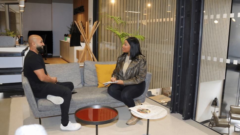 Two people on sofa each face the other and talking