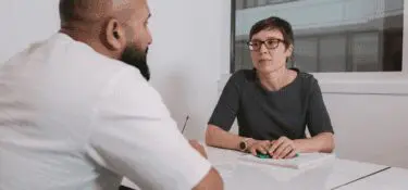 Two people talking at a table