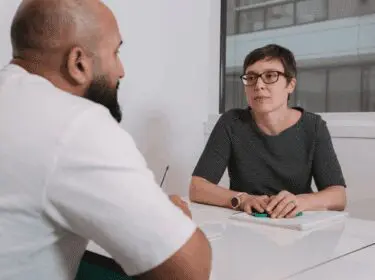 Two people talking at a table