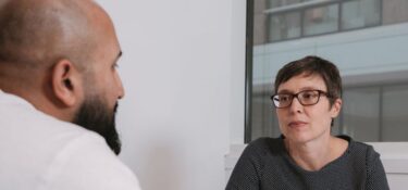 Two people talking at a table