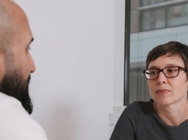 Two people talking at a table