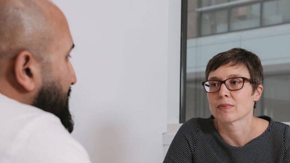 Two people talking at a table