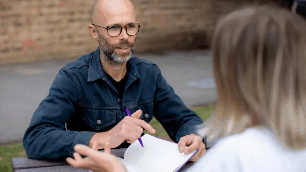 professional man sat across the table from professional woman