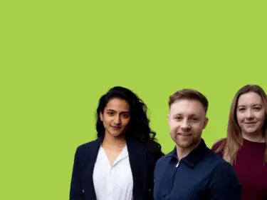 Three people standing side by side against a bright green background.