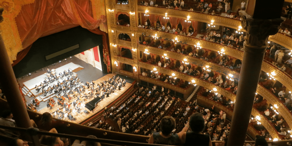view of a theatre stage from up high looking down on stage with lights and performers
