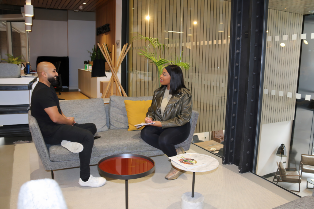 Two people conversing on a couch