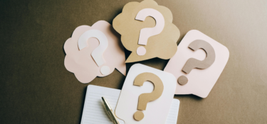 image of four question marks made out of paper